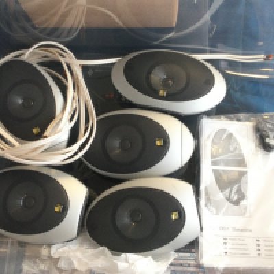 A set of KEF cinema surround speakers (missing subwoofer).