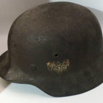 A German Third Reich Steel helmet with faded side decal possible M35 pattern no inner lining. Circa 1942