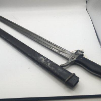 A Military bayonet possible French with an ebony wood grip conforming serial numbers on the quilon and metal scabbard length 50cm approximately.