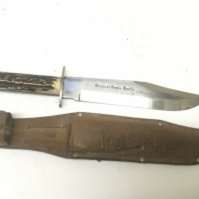 A Vintage Hunting Bowie Knife with a horn handle grip the blade stamped Original Bowie Knife with makers marks and leather embossed scabbard.