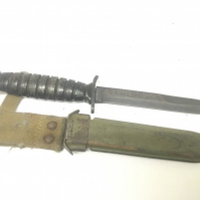 A US II world war fighting knife the blade stamped US M3 1943. Nice original example showing good wear in keeping with war use.with metal scabbard and woven belt frog.