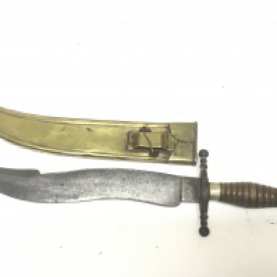 An Antique Knife with steel blade of Kris type with a turned wood grip and brass scabbard. length 45cm