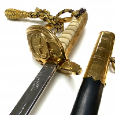 Elizabeth II British Royal Navy Officers dress Sword and Scabbard by Wilkinson Sword. - Brass Hilt, together with Geeves & Hawes Black sword belt & slings with gold plated fittings worn by Officers and Warrant Officers in the Royal Navy. officers name T.P Ward, 113299. plus sword and scabbard protective soft case. (D)