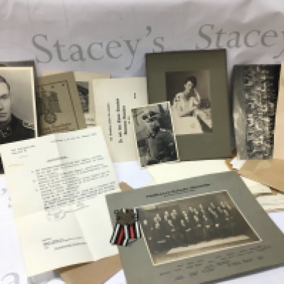A collection of German Third Reich paperwork including Death certificates, Birth certificates, Military passport, photographs etc , postage category A