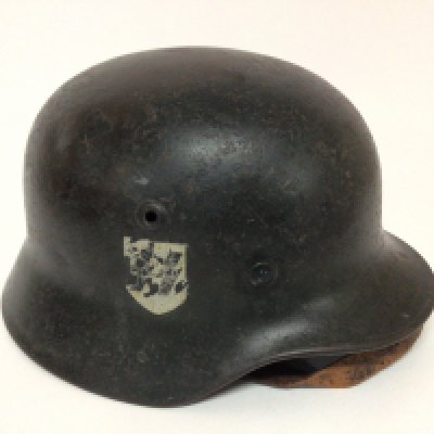 A Genuine and very good example of a World War II German Third Reich Waffen SS helmet with single SS decal the helmet with folded edge and original paintwork leather and aluminium edge. The interior with further original symbols and text SS Strm Lambe and one other symbol.
