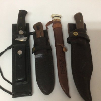 A collection of hunting knifes a Japanese seki knife with leather scabbed two others made by Rory Conner with leather scabbards and one other (4)