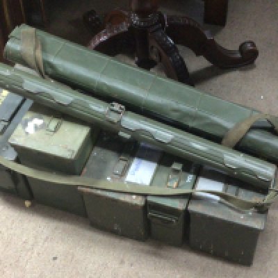 A collection of Military ammunition boxes of mixed size and shape.