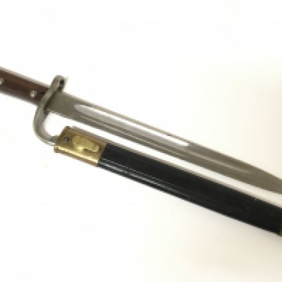 A Brazilian 1908 pattern bayonet commisened by the Brazilian government made by Weyersberg Kirschbaum Solingen. The number on the quillion matching on the brass fittings of the leather scabbard the top section of the bayonet marked with a B.