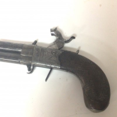An Early 19th century Percussion revolving barrel personal protection pistol maker Manton of London. With a walnut grip retractable trigger the slab sided action pattern engraved with makers name and revolving barrels. A nice example and working action.