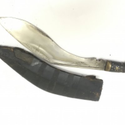 An old Kukri Knife the National weapon of Nepal with an inland horn handle and patterned blade.