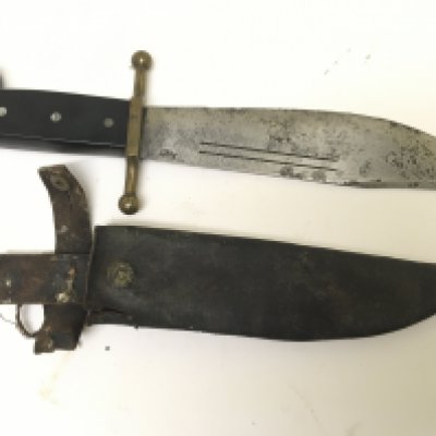 A rare American II world war combat Knife the V44 Bowie Ebony grip and brass cross guard the blade with makers stamp Kinfolks with a leather scabbard. Length 37cm