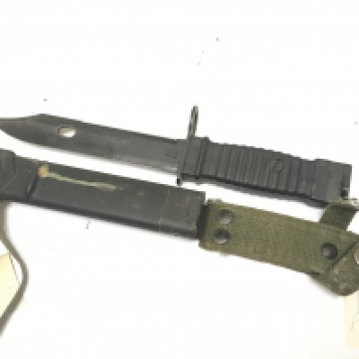 A KCB -70 bayonet with makers mark to the blade for the Erickhorn company also initials NWN the blade with a saw edge the metal scabbard with wire cutter base..