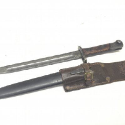 A K98 bayonet with an interesting leather frog stamped 1942 with a South African manufacture Greatrex ltd the blade of the bayonet with further marks.