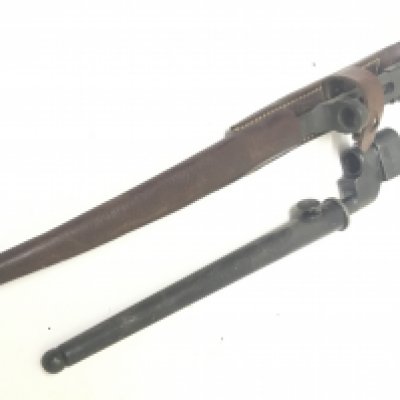 A pig stick bayonet with metal scabbard and one other straight blade bayonet with a leather scabbard.