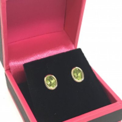 A pair of 9 carat gold and peridot stud earrings. Postage category A
