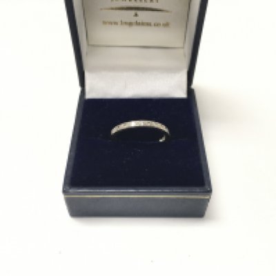 A white metal half eternity ring set with diamonds. Size N.