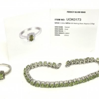 A silver Peridot ring and a silver Peridot tennis bracelet. Postage category A