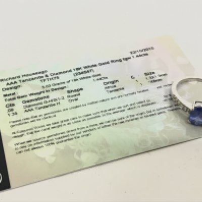 An 18 carat white gold tanzanite and diamond set ring with certificate. 2.7g. N/O Postage category A