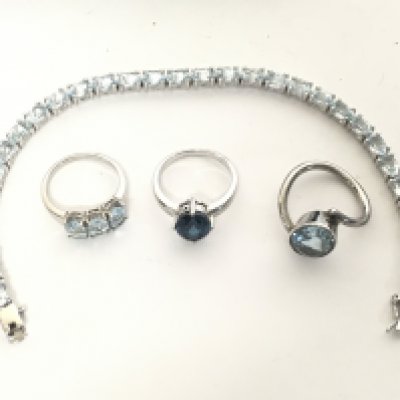 A collection of silver jewellery set with Topaz stones including rings and a tennis bracelet. Postage category Ay
