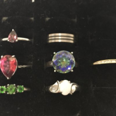 A collection of silver rings including amethyst, opal etc set and a 9 carat gold ring set with diamond shards. Postage category A