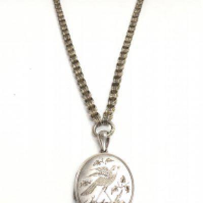 An early 20th century silver hallmarked song bird locket and chain. Postage category A