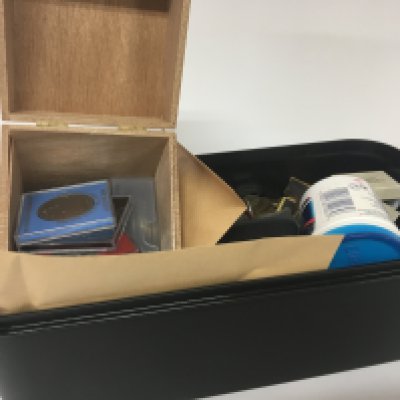 A tub containing a large quantity of mixed used world coinage commemorative crowns.