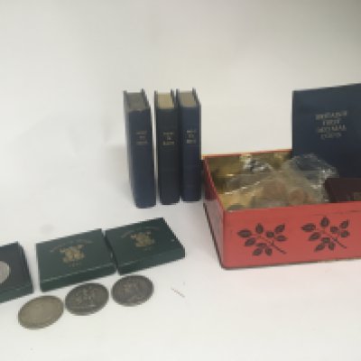 Three green boxed 1951 Festival of Britain coins a 1921 dollar two Victorian crowns a quantity of other coins and unopened How to Dave coin money boxes containing coinage.