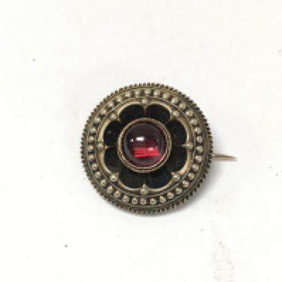 An antique unmarked cabochon garnet set brooch.