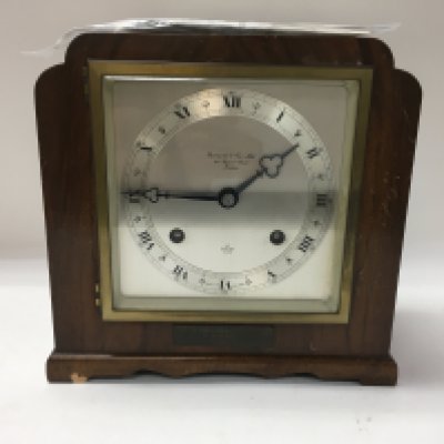 A Garrard wood clock with its guarantee from 1969.