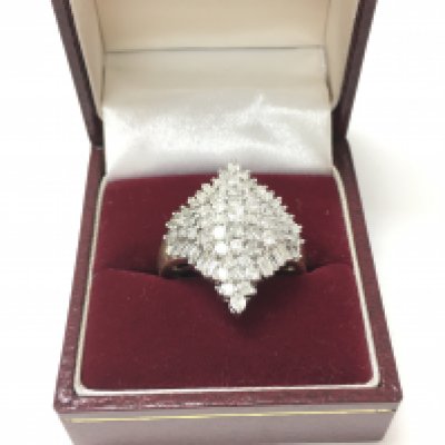 An unmarked diamond cluster ring.