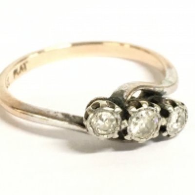 A 9ct gold and platinum three stone diamond ring, size N. 2.3g Postage category A