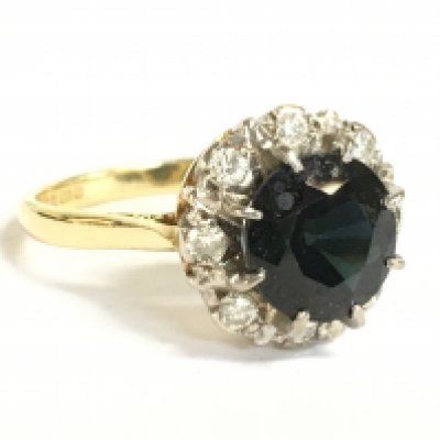 An 18ct gold black sapphire and diamond cluster ring, 5g, size P. Postage category A