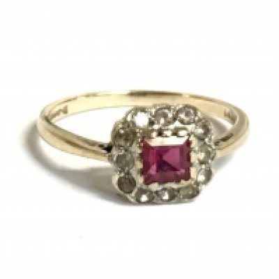 A 9ct gold ring set with a red stone and cubic zirconia stones. 2g.Size N. Postage category a