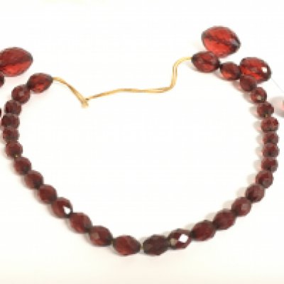 A collection of cherry amber beads. Postage category a