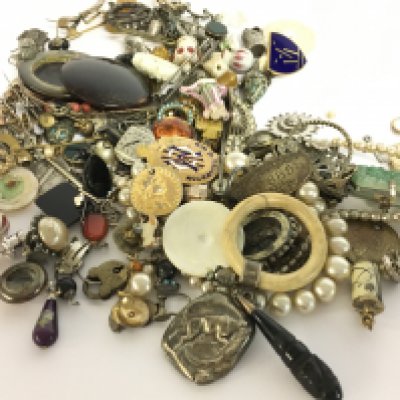 A collection of antique jewellery including a silver hallmarked bull rattle, earrings, stick pins, pendants etc