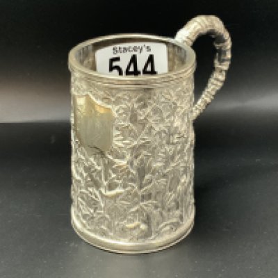A late 19th Century Chinese silver mug with perfuse raised bamboo with small birds Shield with initials. Height 9cm weight 145g