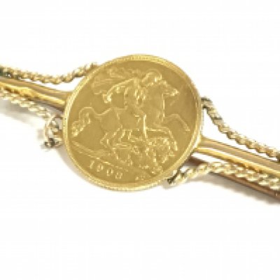 A 1908 Edward half sovereign with a soldered brooch. Total weight 6.4g. Postage category a