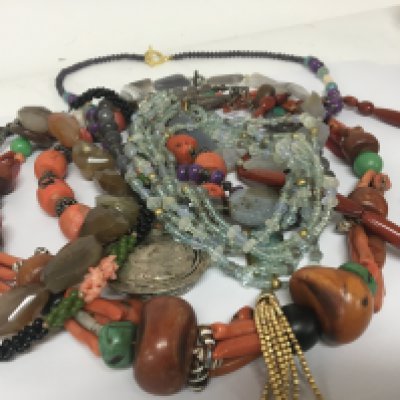 A collection of designer coral and silver necklaces polished stone and crystal necklace.