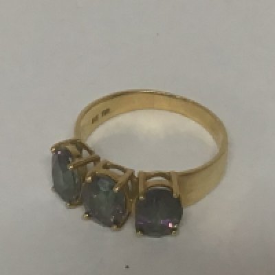 An 18carat gold ring set with three oval cut stones. Ring size R weight 4.5g approximately.