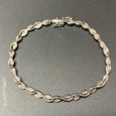 A 9ct white gold and diamonds set line bracelet. (A)