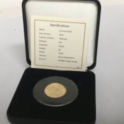 A 22carat gold Alderney coin limited edition of 499 with multi poppy design and certificate of Authenticity.