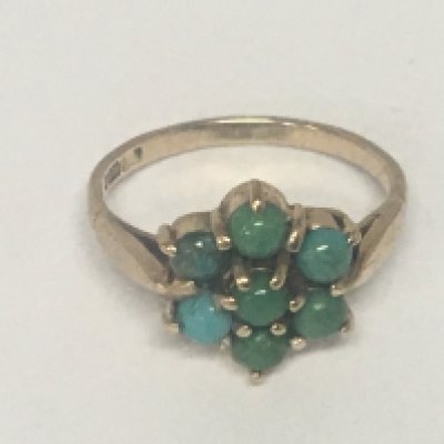 A 9carat gold ring set with a pattern of turquoise.weight 2.5g ring size M.