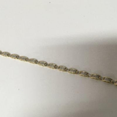A 14 Carat gold bracelet each link pave set with diamonds subdivided by baguette set links. length 18cm approximately weight 15g