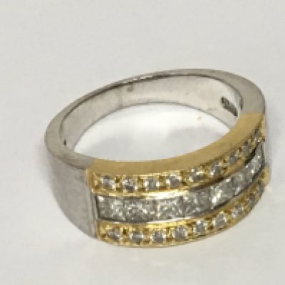 A ladies 14carat white and yellow gold ring pave set with diamonds flanked by two rows of small brilliant cut diamonds. Ring size N. Weight 9g