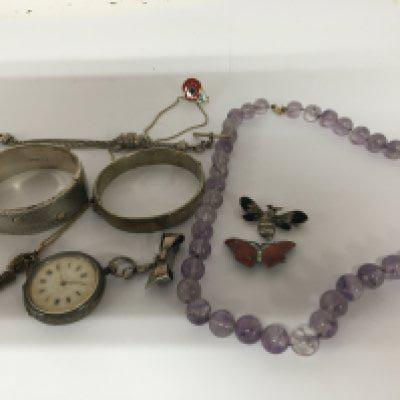Two silver bangles a silver cased watch two silver and enamel brooches a crystal bead necklace and silver watch chain.