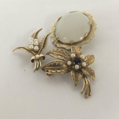 Two 9carat gold brooches set with amethyst and seed pearl total weight 9.4g and one other brooch set with an opaque oval polished stone (3)