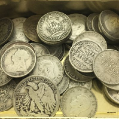 A tin of pre 1946 silver coinage, mostly Shillings. Postage category A
