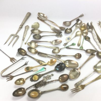 A collection of spoons, forks and other cutlery, some silver. Shipping category B.