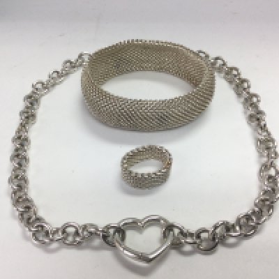 A Tiffany & Co silver mesh ring and bracelet set together with a heavy silver Tiffany heart clasp chain (3). Shipping category B.