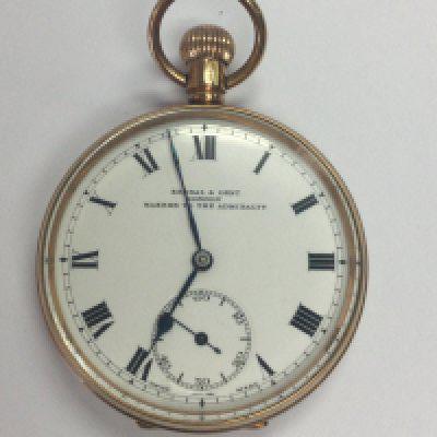 A 9 ct gold button wind pocket watch the enamel dial with Roman numerals maker Kendal and dent London.